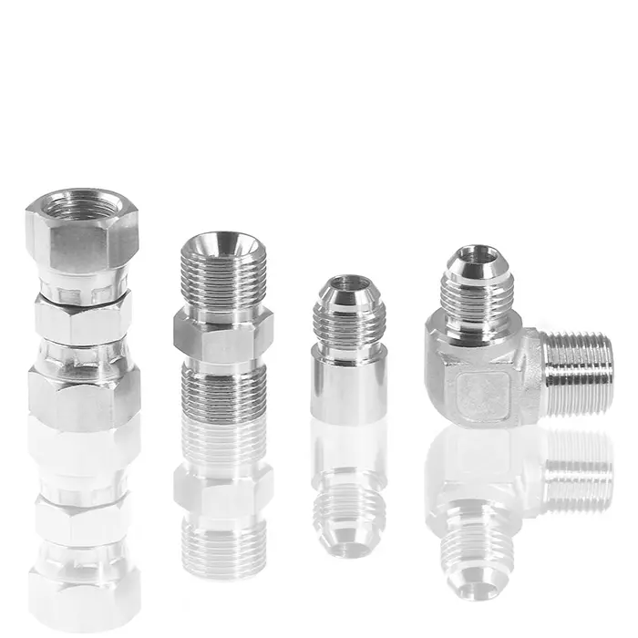A close up studio shot of various JIC 37 degree flare fittings, showcasing their machined threads and conical ends